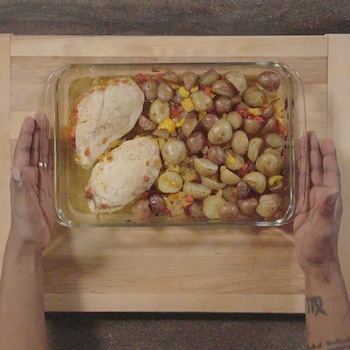 2 poitrines de poulet et des légumes dans un plat de pyrex.
