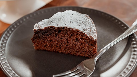 Un morceau de gâteau au cacao et à la lime dans une assiette.