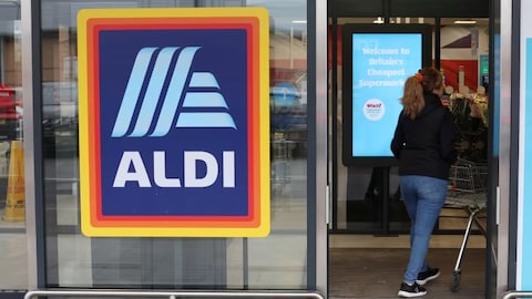 A shopper enters an Aldi supermarket near Altrincham, Britain, in February 2023. The German chain is among several European grocers that the federal government is reportedly courting to enter the Canadian market. 