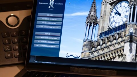 The Canadian Parliament webpage on a laptop. The federal government is coping with apparent cyberattacks this week. (Adrian Wyld/The Canadian Press)