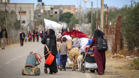 Palestinians evacuate the area targeted by Israel in Rafah.
