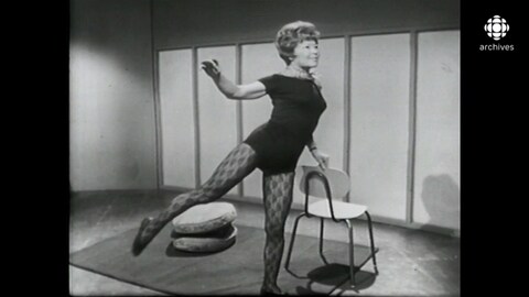 Femme en tenue d'exercice qui fait des mouvements, appuyée sur une chaise.