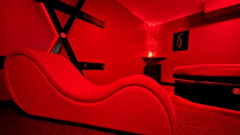 Sex party gatherings can continue to take place at a Calgary home but not under the branding of Club Ménage, a judge has ruled. Pictured is one of the rooms in the home at the centre of the court case.