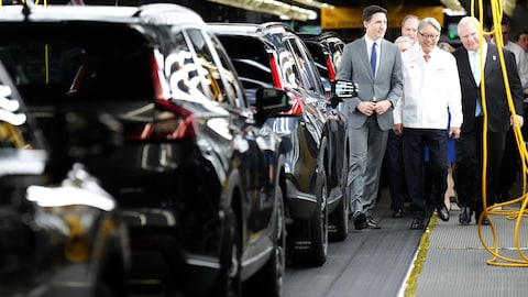 Prime Minister Justin Trudeau, left, Honda CEO Toshihiro Mibe, centre, and Ontario Premier Doug Ford, right, visit Honda's automotive assembly plant in Alliston, Ont., as the company announces plans to build electric vehicles and their parts in Ontario with financial support from the federal and provincial governments, on April 25, 2024.