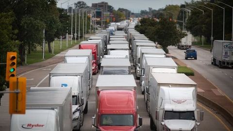 Tractor-trailer traffic is backed up on Huron Church Road, which leads to the Ambassador Bridge, on Aug. 30. Job action by Canadian border workers could have a major impact on traffic and travel times. 