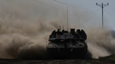 An Israeli tank moves near the Gaza Strip border in southern Israel on March 13, 2024. 