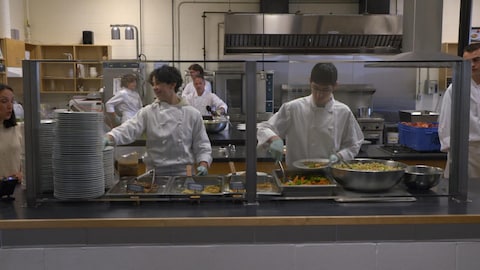 Des jeunes servent les repas à leur école.