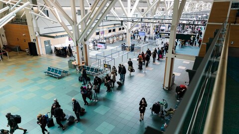 Long lines of travellers are seen at Vancouver International Airport, on Sunday.