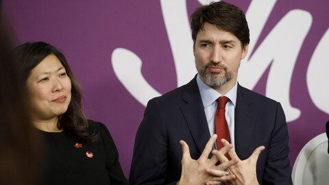 Prime Minister Justin Trudeau is flanked by Mary Ng, the federal minister of small business, export promotion and international trade, at left, and Isabelle Hudon, the Canadian ambassador to France, as he speaks during a round table event at SheEO Global Summit in Toronto, on Monday, March 9, 2020. THE CANADIAN PRESS/Cole Burston