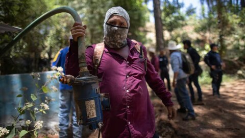 A man shows a pump removed from an unlicensed water intake as his group of residents, farmworkers and small-scale farmers from Villa Madero, Mexico, dismantle illegal water taps in nearby mountains on April 17.