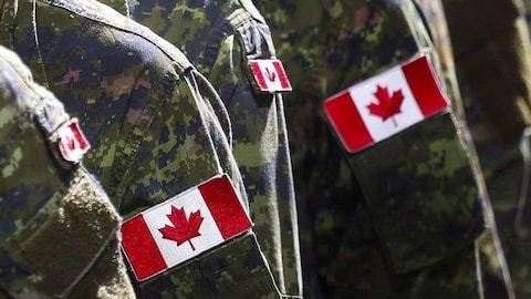 Closeup of the Canadian flag on soldiers' uniforms.