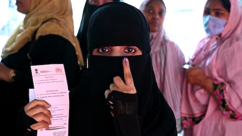 A Muslim woman shows her inked finger after casting her ballot in India's general election, in Hyderabad on May 13. 