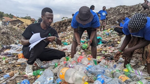 Volunteers from Green Africa Youth Organization and End Plastic Pollution Uganda examine branded plastic waste and record brand audit data in Kampala, Uganda. 