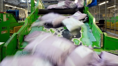 Parcels slide down a ramp after being scanned at the U.S. Customs and Border Protection overseas mail inspection facility at Chicago's O'Hare International Airport in February 2024 in Chicago. 