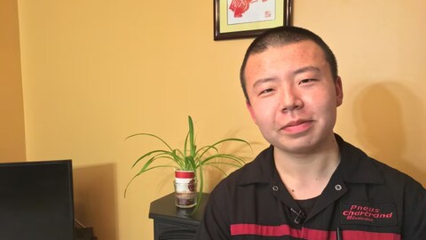 Xianqi Cheng is trying hard to learn French, but a surprise French oral examination mandated by the Quebec government has him worried he will be forced to leave the province. (Elias Abboud/CBC)