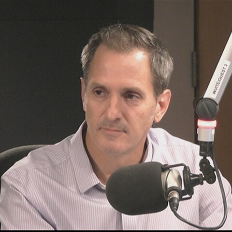 Philippe Richer est assis derrière un microphone dans un studio. Philippe Richer est assis derrière un microphone dans un studio.