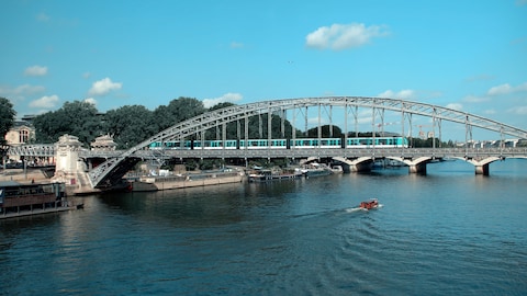 Un train traverse un pont au dessus d'une rivière.