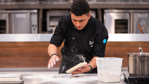 Dans la cuisine des Chefs, Amine saupoudre sa pâte de farine.