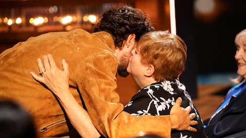Nicole, la mère de Lou-Pascal Tremblay, embrasse son fils sur la joue.