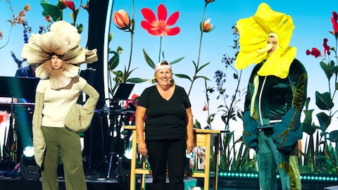 Juste pour rire Télévision Le trio est sur une scène décorée de fleurs. Silvi Tourigny et Philippe Laprise sont déguisée en fleurs.