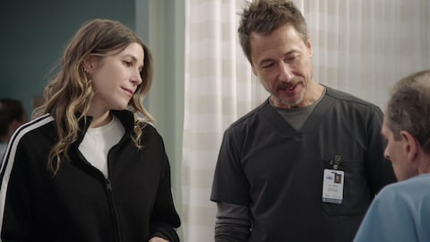 Delphine et Éric font face à un patient qui est assis dans un lit d'hôpital.