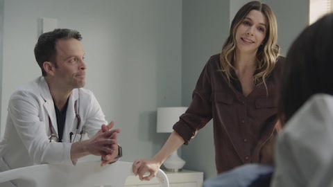 Dans la série Stat, Steve et Delphine parlent avec une patiente dans son lit d'hôpital.