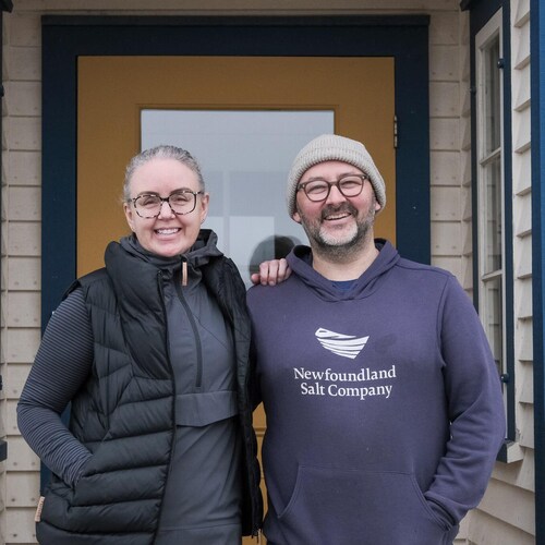 Un homme et une femme sourient à la caméra.