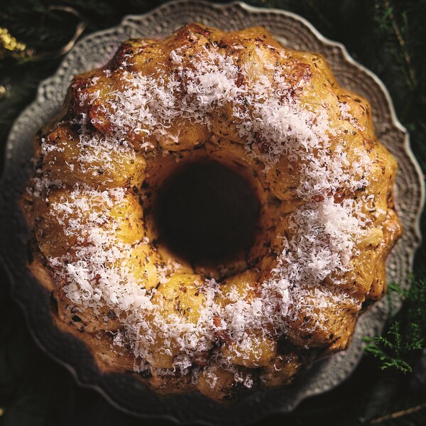 Un monkey bread aux herbes et aux fromages dans une assiette de service.