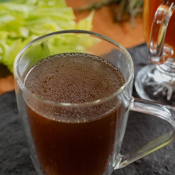 Du bouillon de poulet fait maison, servi dans une tasse en vert.