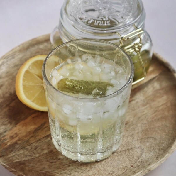 Un verre d'eau pétillante aromatisée au jus de cornichons.