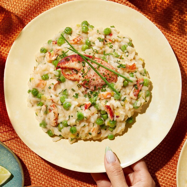 Une assiette contenant du risotto au homard, au mascarpone et aux petits pois.