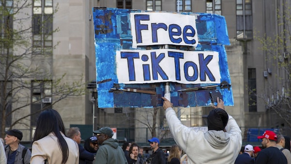 FILE - A man carries a Free TikTok sign in front of the courthouse where the hush-money trial of Donald Trump got underway April 15, 2024, in New York. The House has passed legislation Saturday, April 20, to ban TikTok in the U.S. if its China-based owner doesn't sell its stake, sending it to the Senate as part of a larger package of bills that would send aid to Ukraine and Israel. House Republicans' decision to add the TikTok bill to the foreign aid package fast-tracked the legislation after i