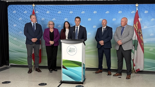 Le premier ministre Rob Lantz est entouré de gauche à droite des ministres Bloyce Thompson, Darlene Compton, Jill Burridge, Robin Croucher et Ken Dollar.