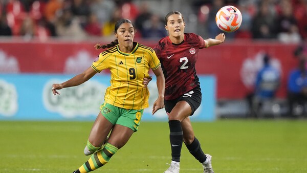 Sydney Collins est à la lutte avec Kameron Simmonds pour le contrôle du ballon.