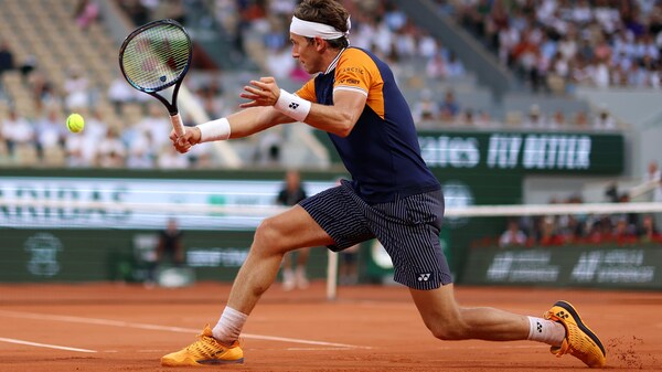 Casper Ruud frappe la balle de tennis.