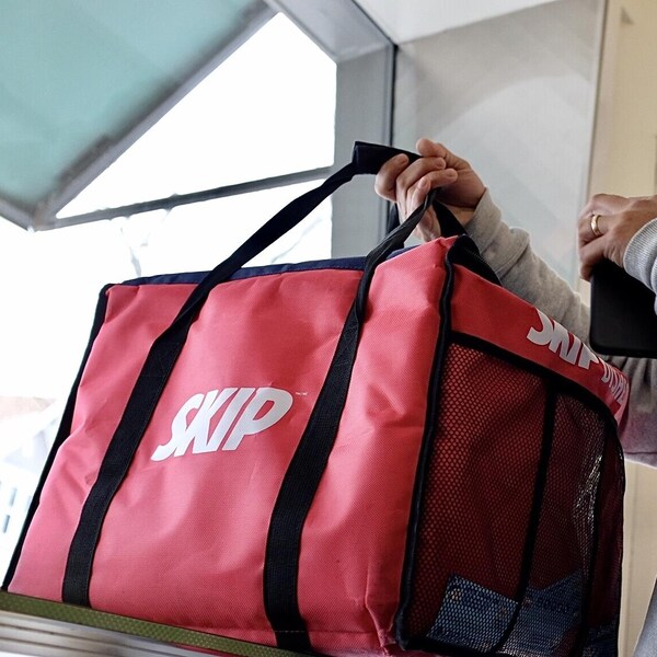 Un livreur de SkipTheDishes place un sac de livraison de nourriture sur un comptoir à Moncton, au Nouveau-Brunswick, le 4 janvier 2021.