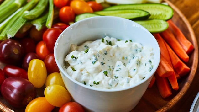 Quick onion dip in a bowl with raw vegetables.