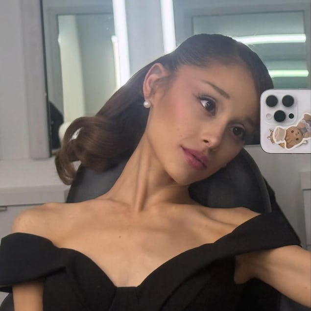 Ariana Grande prend un égoportrait devant un miroir.