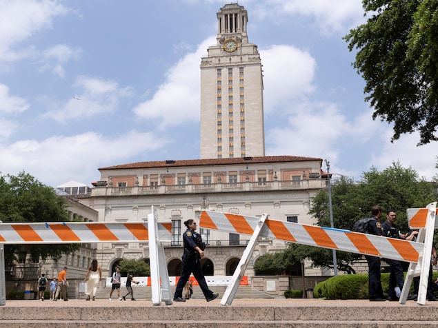 A police officer walks past barricades erected to block The Tower in advance of a pro-Palestinian protest expected tomorrow at the University of Texas, during the ongoing conflict between Israel and the Palestinian Islamist group Hamas, in Austin, Texas, U.S. April 30, 2024.    REUTERS/Nuri Vallbona