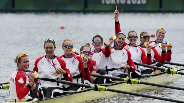 Lisa Roman, Kasia Gruchalla-Wesierski, Christine Roper, Andrea Proske, Susanne Grainger, Madison Mailey, Sydney Payne, Avalon Wasteneys and Kristen Kit of Canada celebrate winning the gold medal in the women's rowing eight final at the 2020 Summer Olympics, Friday, July 30, 2021, in Tokyo, Japan. (AP Photo/Lee Jin-man)