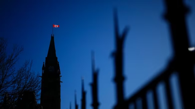 The Canadian flag catches the morning light on the Peace Tower on Parliament Hill in Ottawa on April 16. 