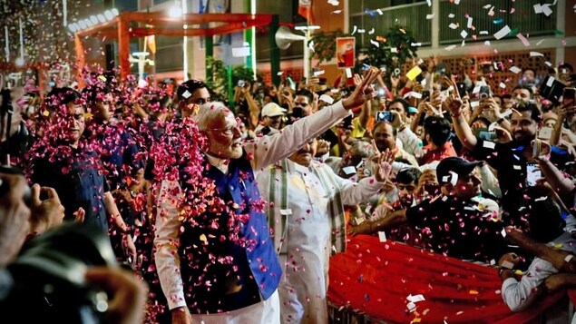 Indian Prime Minister Narendra Modi is greeted by supporters as he arrives at Bharatiya Janata Party (BJP) headquarters in New Delhi on Tuesday. His party appeared likely to lose a significant number of seats in the country's election, falling shy of an outright majority. 