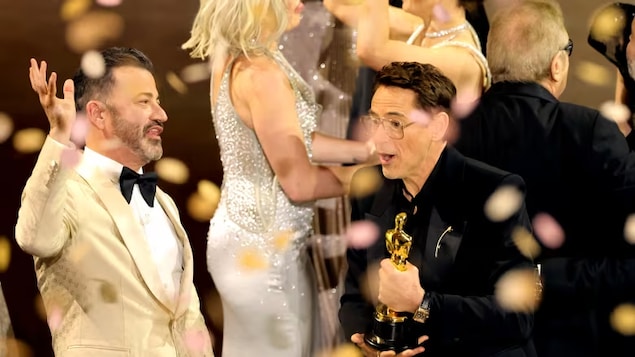 Robert Downey Jr., right, accepts an award for Oppenheimer during the 96th Annual Academy Awards. The film was the big winner of the Oscars, taking home seven.