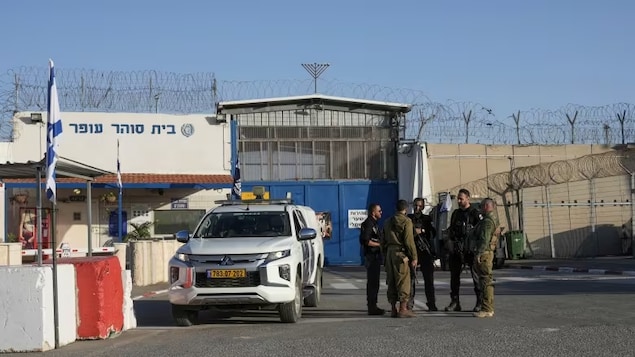 Israeli soldiers stand outside Ofer military prison in the West Bank on Nov. 24, at the start of a temporary ceasefire in the Israel-Hamas war. (Mahmoud Illean/The Associated Press)
