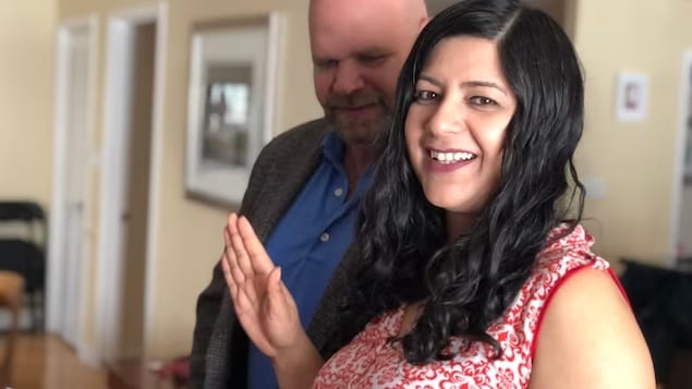 Neha Singh of Sudbury, Ont takes the official Canadian citizenship oath during a ceremony on Zoom on Monday, while her husband Jake Tapper looks on. (Angela Gemmill/CBC)