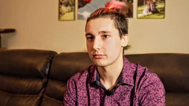 Trofim Modlyi, 19, who's from eastern Russia, was visiting his sister in Grande Prairie, Alta., when Russia invaded Ukraine last February. He decided to apply for refugee status in Canada after his parents back home received a conscription notice for him to fight in the war. (Luke Ettinger/CBC)