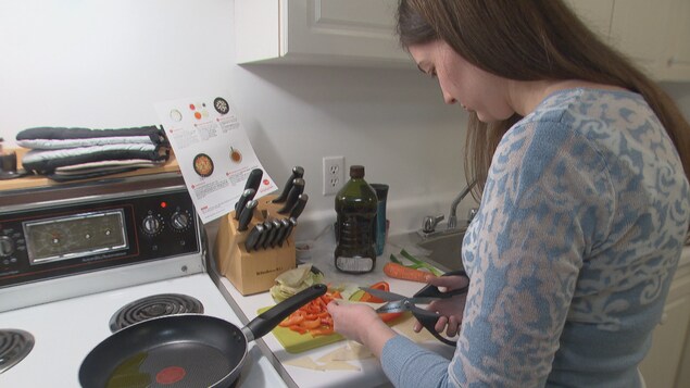 Une femme en train de couper des légumes Une femme en train de couper des légumes