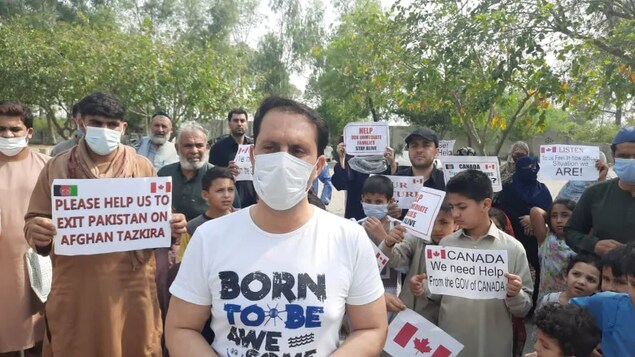 A group of Afghans seeking to come to Canada on special immigration measures for former employees of the government and their families, hold a protest over travel delays in Islamabad on Canadian consular grounds in early May. (Submitted/Asad Ali Afghan )