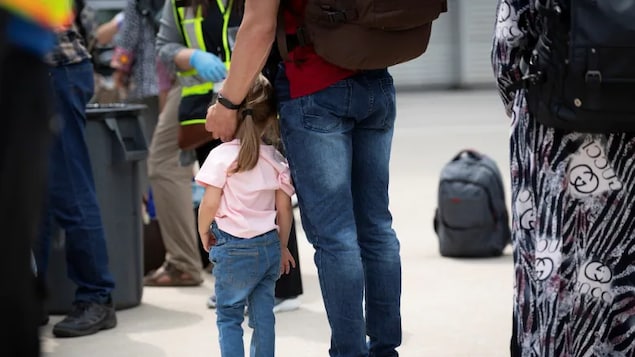 Afghan refugees who supported Canada’s mission in Afghanistan wait to board buses in Mississauga after arriving in Canada at Toronto's Pearson International Airport last month.