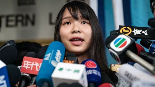 Hong Kong pro-democracy activist Agnes Chow speaks to members of the media at the Eastern Magistrates' Courts after being arrested and released on bail on Aug. 30, 2019, in Hong Kong. Chow has moved to Toronto and says she's unlikely to return to Hong Kong.